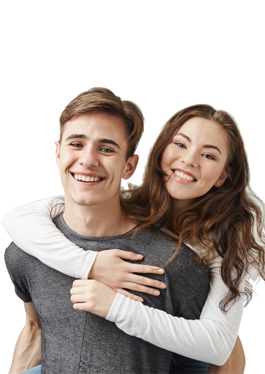 couple hugging and laughing near the wall